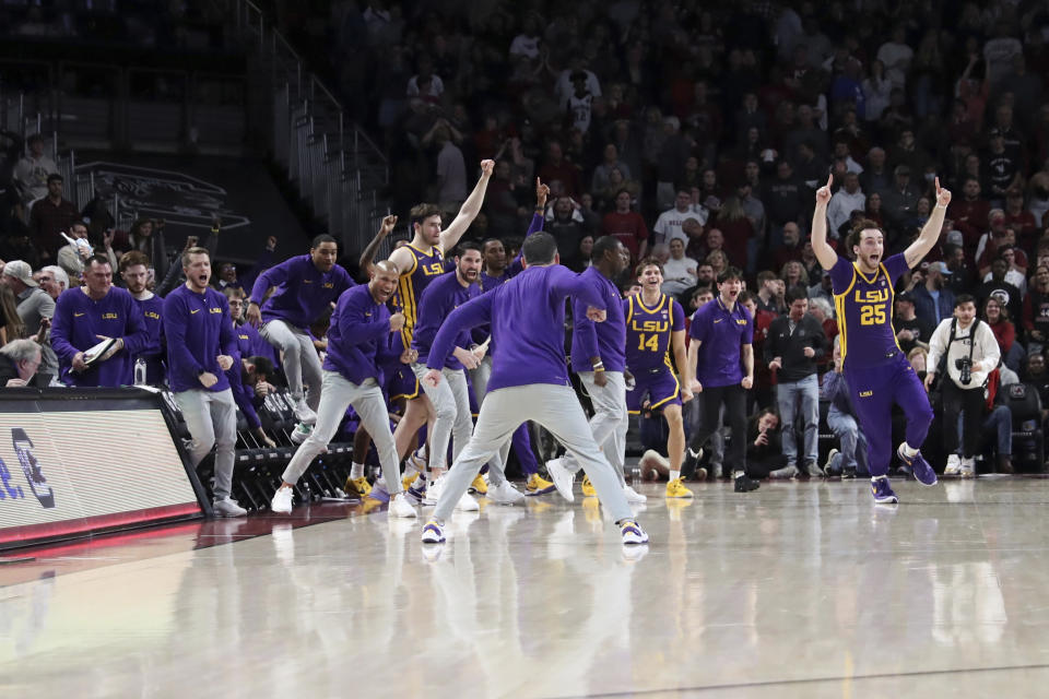 LSU celebrates after upsetting South Carolina during an NCAA college basketball game Saturday, Feb. 17, 2024, in Columbia, S.C. LSU won 64-63. (AP Photo/Artie Walker Jr.)