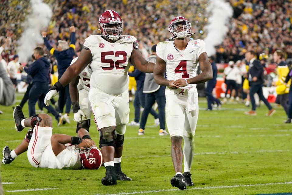 Alabama quarterback Jalen Milroe (4) and offensive lineman Tyler Booker (52) walk off the field after a loss to Michigan in their College Football Playoff semifinal at the 2024 Rose Bowl in Pasadena, Calif.