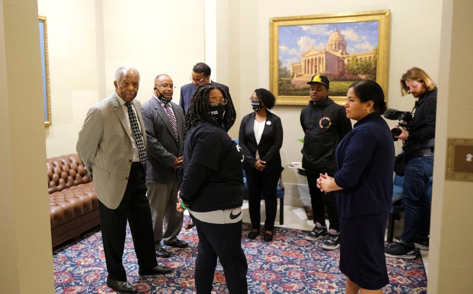 Antoinette Jones, the sister of death-row inmate Julius Jones, prays with ministers and other Julius Jones' supporters in the waiting room at Gov. Kevin Stitt's office.