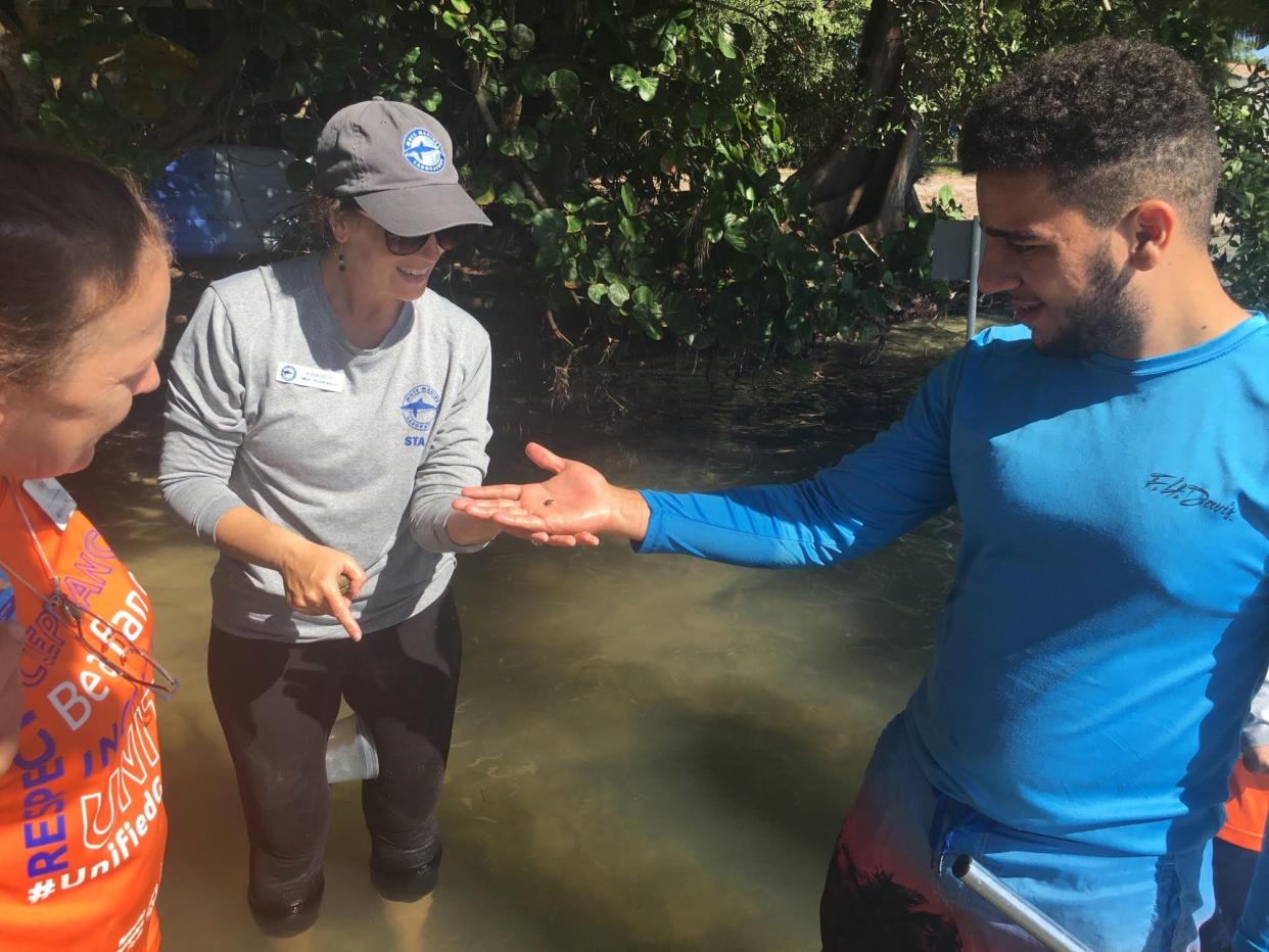 From left, Easterseals educator Michele Kolp and Mote Community Engagement Coordinator Alison Goldy examine a snail with Easterseals student Gabriel Silverio. Mote recently received a $10,000 grant to support its C-STEM Program.