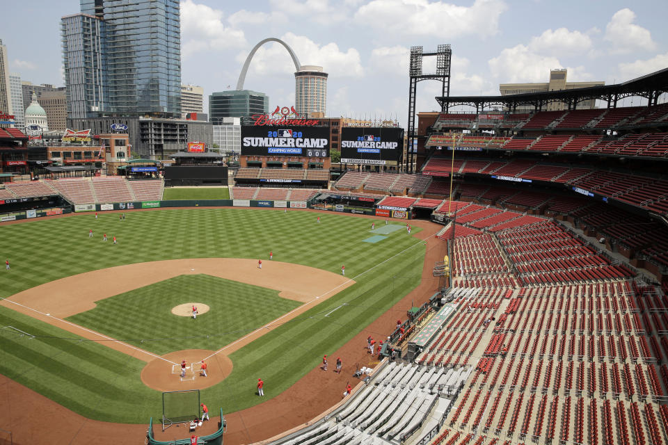 Members of the St. Louis Cardinals take the field during baseball practice at Busch Stadium Friday, July 3, 2020, in St. Louis. (AP Photo/Jeff Roberson)