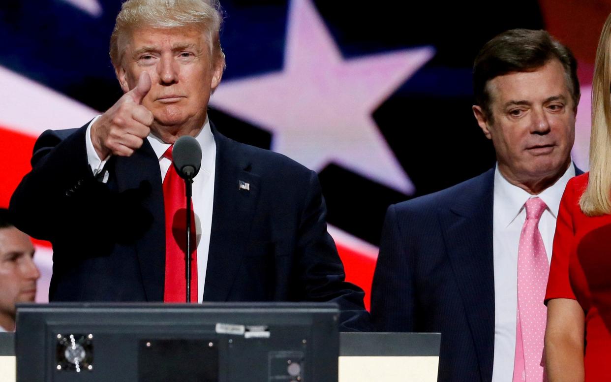 Then-Republican presidential nominee Donald Trump gives a thumbs up as his campaign manager Paul Manafort looks on - REUTERS
