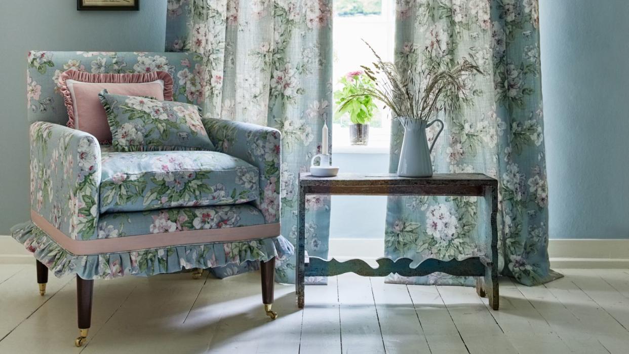  Blue armchair in front of matching blue drapes 