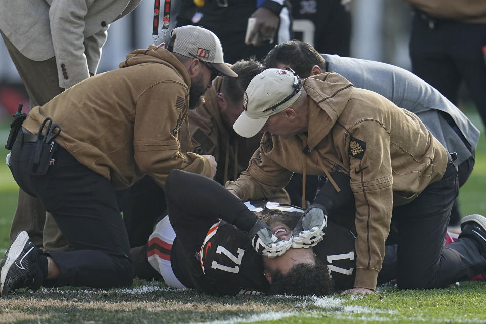 Cleveland Browns offensive tackle Jedrick Wills Jr. (71) reacts while being tended to after an injury during the second half of an NFL football game against the Arizona Cardinals Sunday, Nov. 5, 2023, in Cleveland. (AP Photo/Sue Ogrocki)