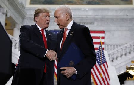 U.S. President Donald Trump is greeted by Sen. Orrin Hatch (R-UT) prior to speaking at the Utah State Capitol in Salt Lake City, Utah, U.S., December 4, 2017. REUTERS/Kevin Lamarque