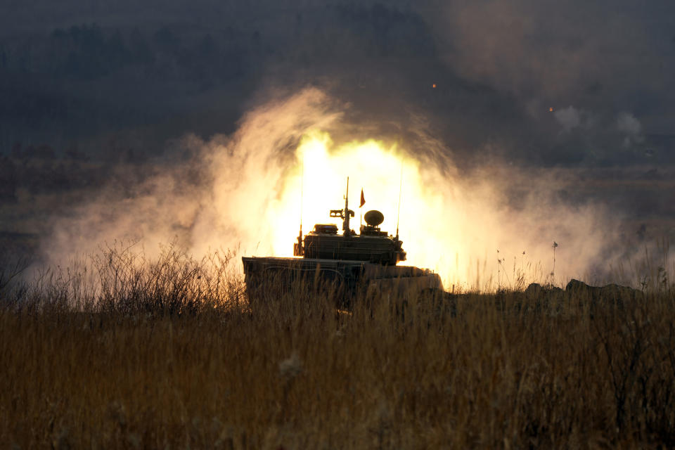 Japanese Ground-Self Defense Force (JGDDF) Type 90 tank fires its gun at a target during an annual exercise at the Minami Eniwa Camp Tuesday, Dec. 7, 2021, in Eniwa, Japan's northern island of Hokkaido. Dozens of tanks are rolling over the next two weeks on Hokkaido, a main military stronghold for a country with perhaps the world's most little known yet powerful army. (AP Photo/Eugene Hoshiko)