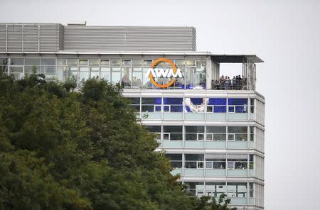 People stand on a balcony of a building overlooking the scene of a shooting rampage at the Olympia shopping mall in Munich, Germany July 22, 2016. REUTERS/Michael Dalder