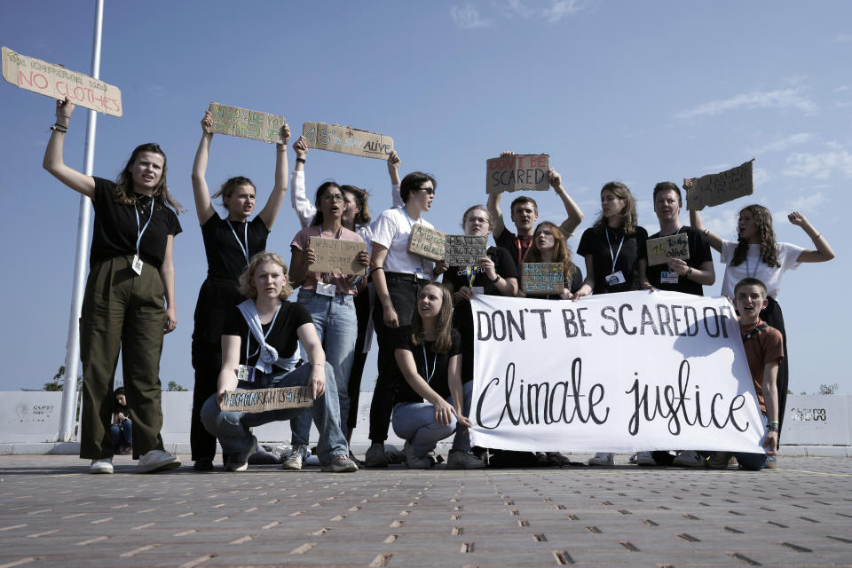 Climate activists participate in a demonstration holding a sign that reads "don't be scared of climate justice" at the designated protest zone for the COP27 U.N. Climate Summit, Tuesday, Nov. 15, 2022, in Sharm el-Sheikh, Egypt. (AP Photo/Nariman El-Mofty)