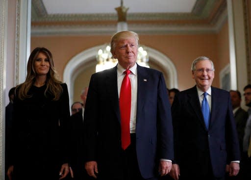 President-elect Donald Trump and his wife Melania walk with Senate Majority Leader Mitch McConnell of Ky. on Capitol Hill, Thursday, Nov. 10, 2016, after a meeting.