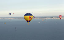 IN FLIGHT, UNITED KINGDOM - APRIL 07: Hot air balloons which departed from Lydden Hill race circuit near Canterbury take part in a mass crossing of the English Channel on April 7, 2011 near Dover, England. 51 balloonists of various nationalities from across Europe took off from Kent making for Calais, France at about 7am. It is the first time a Guinness World Record bid has been made for "the largest group of hot air balloons to make the Channel crossing". (Photo by Oli Scarff/Getty Images)