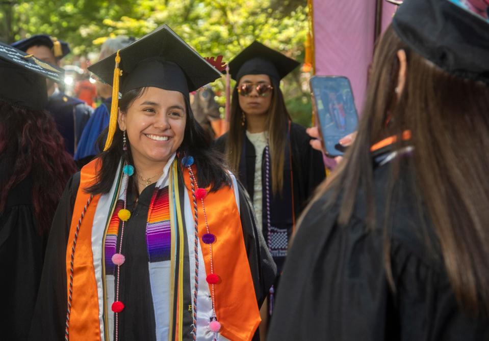 University of the Pacific graduate Ana Jimenez, left, has her picture taken by fellow grad Alexis Rabago before the start of commencement ceremonies.