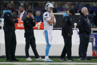 Carolina Panthers quarterback Sam Darnold, center, watches his team play during the second half of an NFL football game against the New York Giants, Sunday, Oct. 24, 2021, in East Rutherford, N.J. (AP Photo/Seth Wenig)