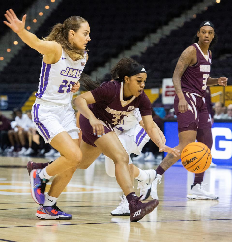 Texas State's Kennedy Taylor (No. 3) drives past James Madison's Caroline Germond (No. 20) during the SBC Women's Basketball Championship game at the Pensacola Bay Center on Monday, March 6, 2023.