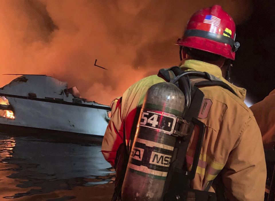 In this photo provided by the Ventura County Fire Department, VCFD firefighters respond to a boat fire off the coast of southern California, Monday, Sept. 2, 2019. The U.S. Coast Guard said it has launched several boats to help over two dozen people "in distress" off the coast of southern California. (Ventura County Fire Department via AP)