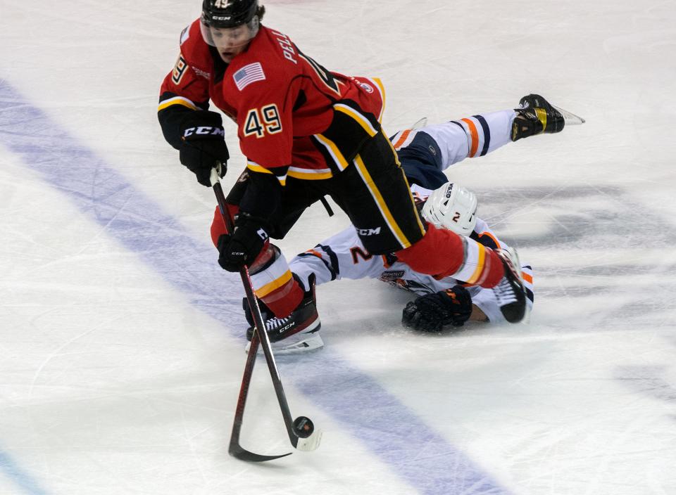 Stockton Heat's Jakob Pelletier, left, gets past Bakersfield Condors' Philip Broberg on his way to score a goal during the first round of the Calder Cup playoffs Tuesday at the Stockton Arena.