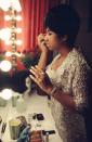 <p>Aretha Franklin fixes her makeup backstage, wearing a gold lace gown and delicate jewels, before a performance at Symphony Hall in Newark, N.J. (Photo: Getty Images) </p>