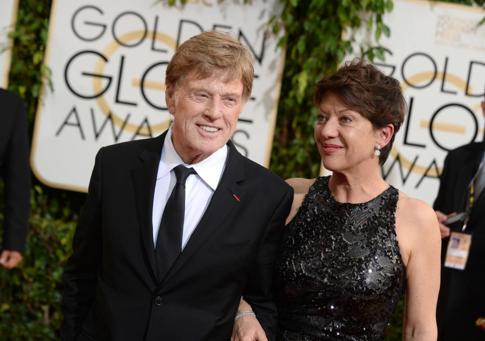 Robert Redford, left, and Sibylle Szaggars arrive at the 71st annual Golden Globe Awards at the Beverly Hilton Hotel on Sunday, Jan. 12, 2014, in Beverly Hills, Calif. (Photo by Jordan Strauss/Invision/AP)