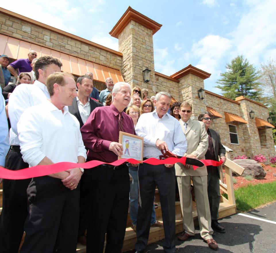 In this May 2014 file photo, senior VP of Double Diamond Companies, Randy Gracy, cuts the ribbon for the long-awaited grand opening of Lost Lake Resorts in Forestburgh. The project never came to fruition and the current developer is now clashing with the town over permit denials.