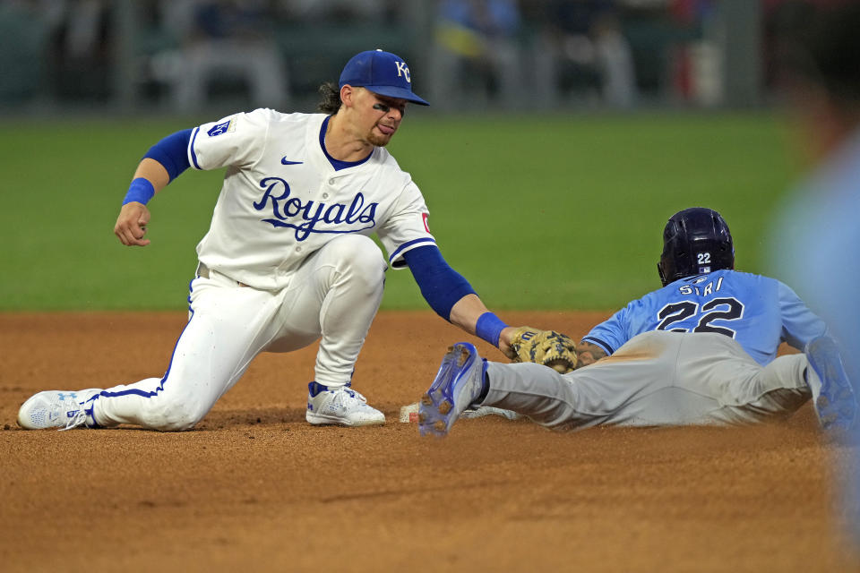 Tampa Bay Rays' Jose Siri (22) beats the tag by Kansas City Royals shortstop Bobby Witt Jr. to steal second during the fourth inning of a baseball game Tuesday, July 2, 2024, in Kansas City, Mo. (AP Photo/Charlie Riedel)