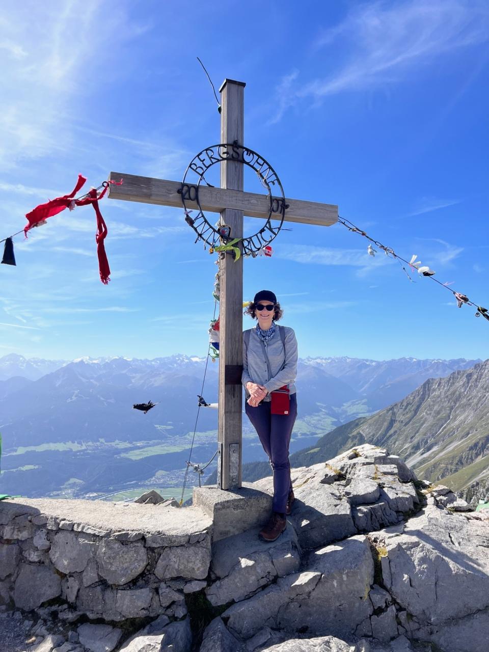 Julie is happy outdoors and up a mountain with her camera in hand