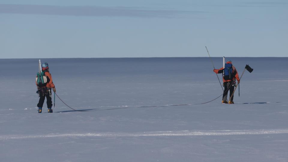Two scientists walk across the Brunt Ice Shelf