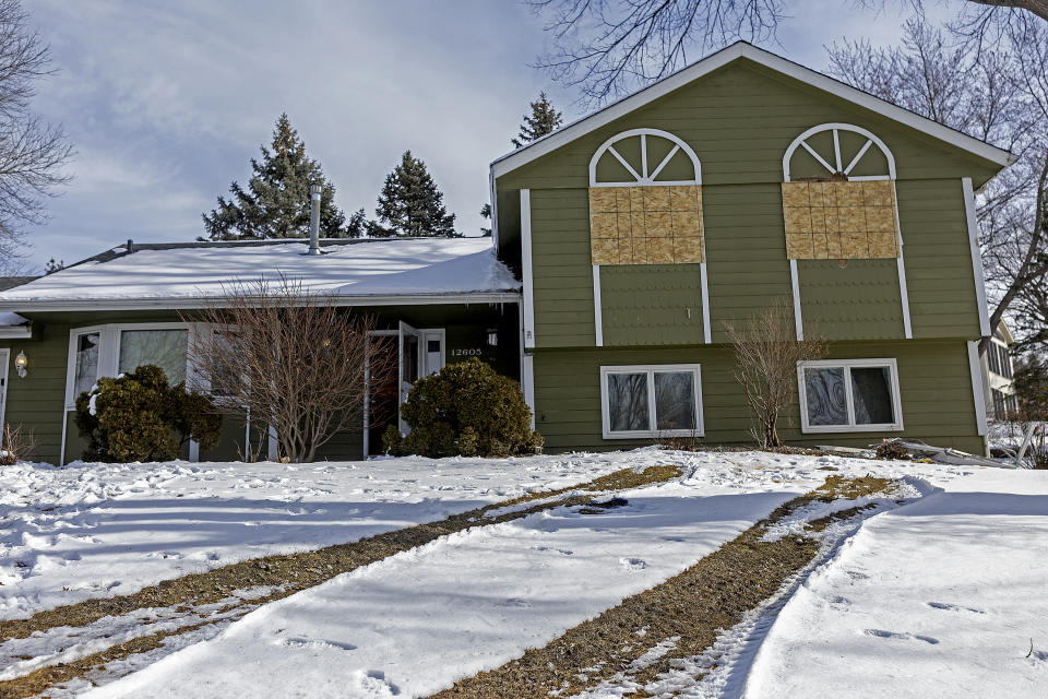 The home where two Burnsville cops and a paramedic were shot and killed by a gunman sits boarded up in Burnsville, Minn., Monday, Feb. 19, 2024. The first responders were shot and killed early Sunday and a third officer was injured at a suburban Minneapolis home in an exchange of gunfire while responding to a call involving an armed man who had barricaded himself inside with family. (Elizabeth Flores/Star Tribune via AP)