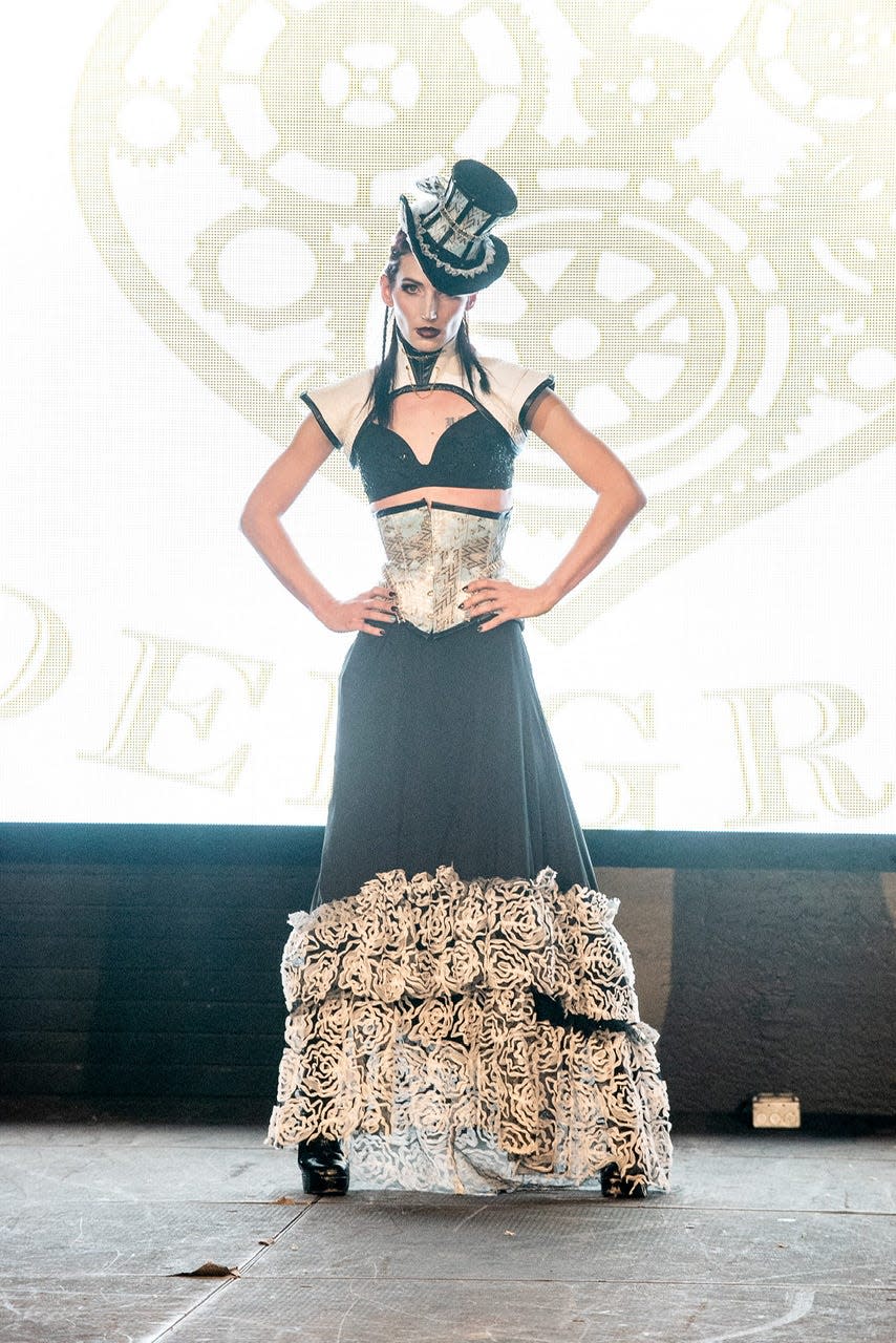 Hannah Noelle models a black and white outfit and top hat during a fashion show in downtown Phoenix in January 2020.