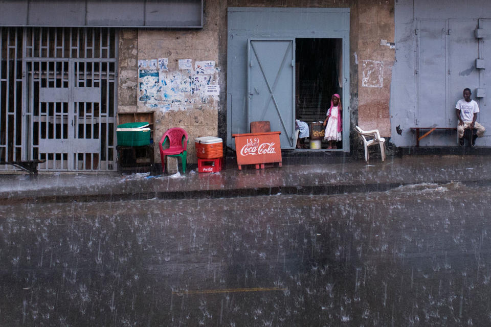 A little girl looks out onto Ashmun Street in Monrovia. Rainy season lasts more than half the year in Liberia. | Kathleen Flynn, special to ProPublica