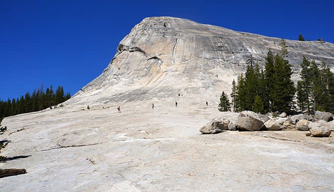 People walking up the face of Lembert Dome in Yosemite. Photo by Gloria Wadzinski