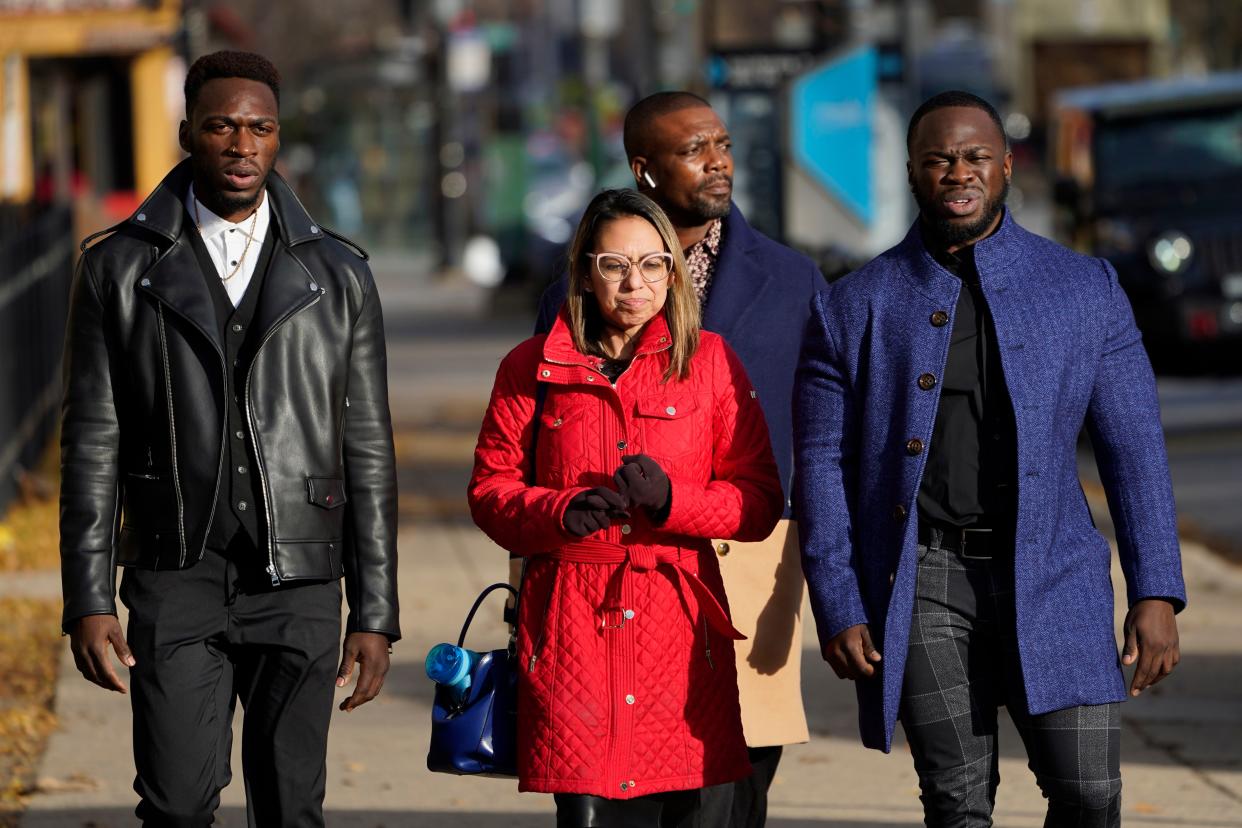 Attorney Gloria Schmidt Rodriguez, center, walks with her clients Abimbola Osundairo, left, and Olabinjo Osundairo, as they arrive at the Leighton Criminal Courthouse to testify in the trial of actor Jussie Smollett Thursday, Dec. 2, in Chicago. 