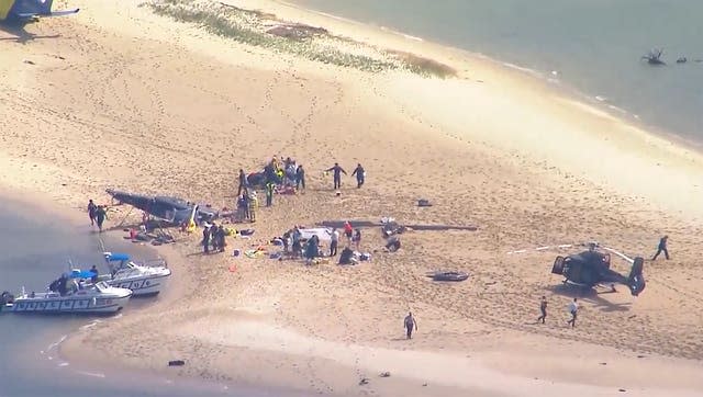 A sand island with crashed helicopter, victims and emergency services on Gold Coast, Australia Monday, Jan. 2, 2023