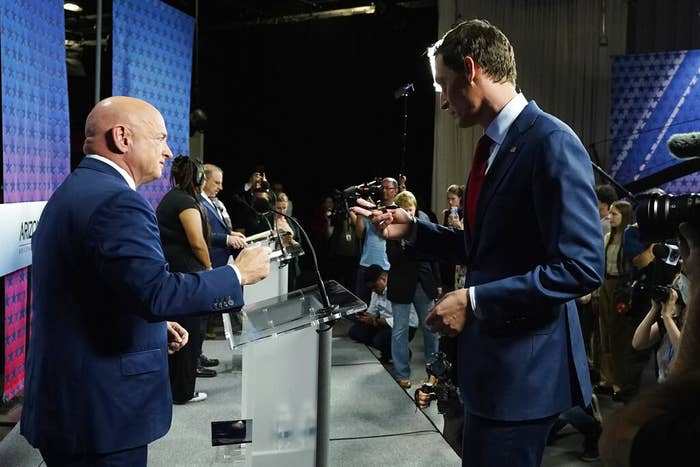 Arizona Democratic Sen. Mark Kelly (left) talks with his Republican challenger Blake Masters prior to a televised debate in Phoenix, Oct. 6, 2022.