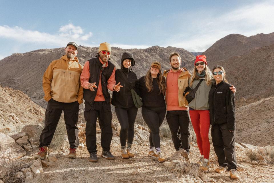 a group of people posing for a photo on a mountain