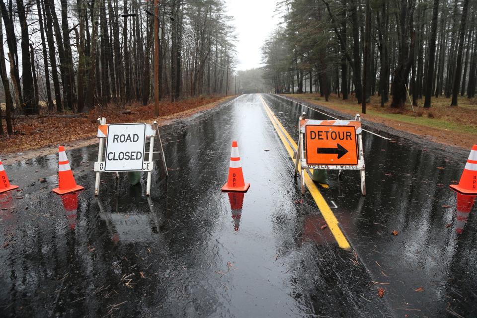 Road closure signs at the junction of Baer Road and Route 103 leading from Eliot, Maine, to Dover are keeping traffic out as heavy winds bringing trees and wires down Monday, Dec. 18, 2023.