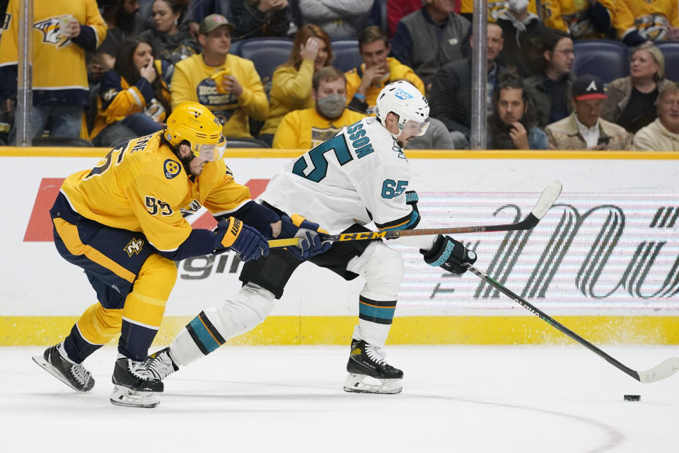 Nashville Predators center Matt Duchene (95) tries to slow down San Jose Sharks defenseman Erik Karlsson (65) in the second period of an NHL hockey game Tuesday, Oct. 26, 2021, in Nashville, Tenn. (AP Photo/Mark Humphrey)