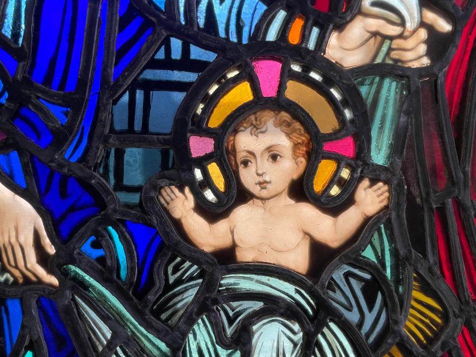 The Infant Jesus is sitting up, chest exposed, and his arms lifted up in prayer in this stained glass window that Donna Barron gifted to St. Rita Catholic Church in Alexandria. Father Joshua Burch said he's maintaining the Orans Posture which gives more significance to his priestly role, he said. The Orans Posture is limited to the priest. Many times, the Infant Jesus’ hand will be depicted in blessing, he said.