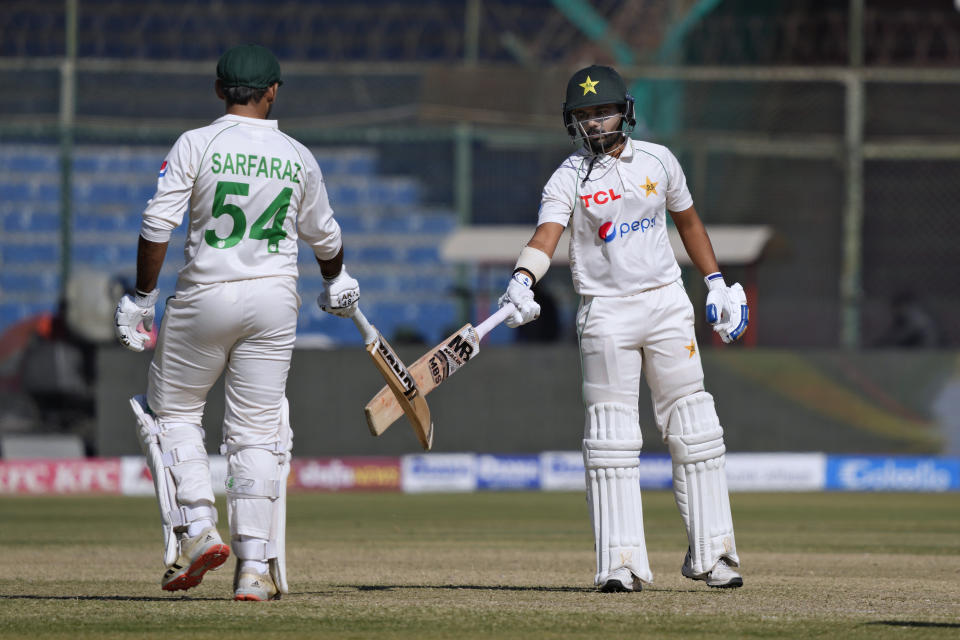 Pakistan's Saud Shakeel, right, celebrates with Sarfraz Ahmed after hitting a boundary during the third day of the second test cricket match between Pakistan and New Zealand, in Karachi, Pakistan, Wednesday, Jan. 4, 2023. (AP Photo/Fareed Khan)