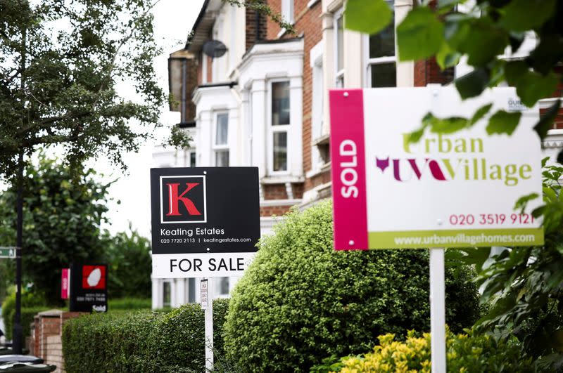 FILE PHOTO: Estate agent signs are seen outside a residential housing in south London