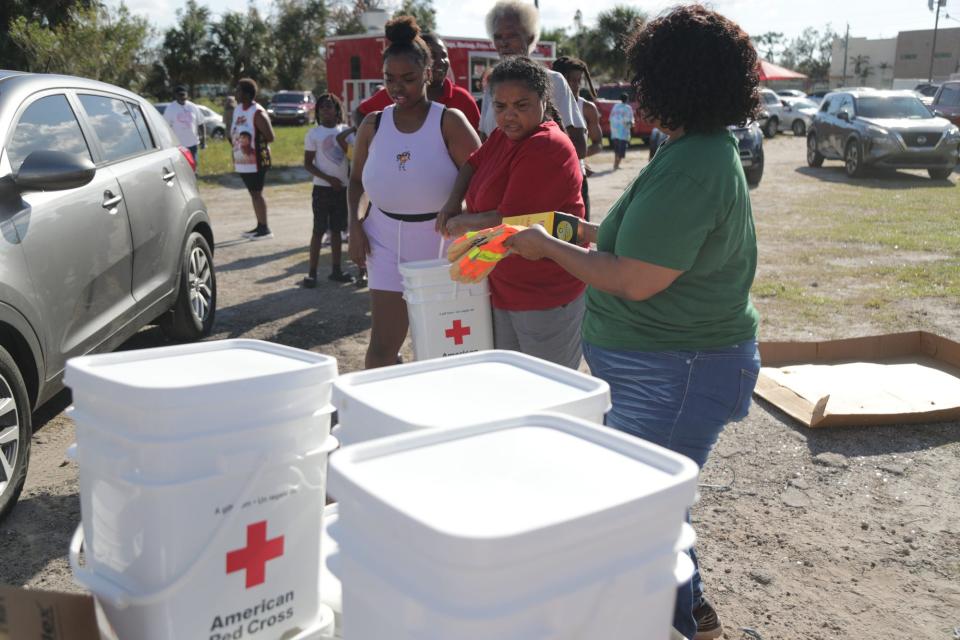 Dunbar residents get cleaning supplies from the Red Cross on Tuesday, Oct. 4, 2022, in Fort Myers.