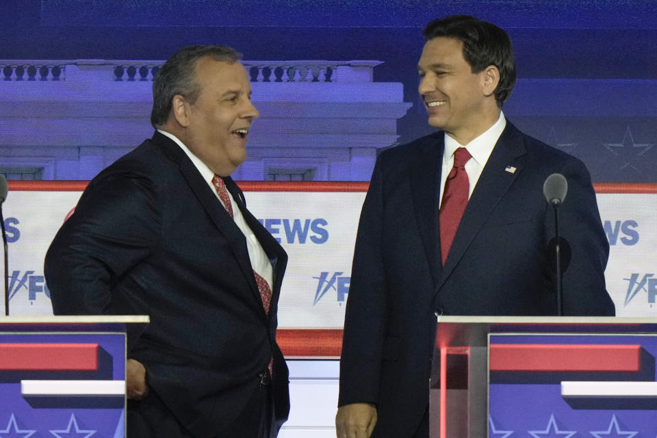 Former New Jersey Gov. Chris Christie talks with Florida Gov. Ron DeSantis during a break in the Republican presidential primary debate hosted by FOX News Channel Wednesday, Aug. 23, 2023, in Milwaukee. (AP Photo/Morry Gash)