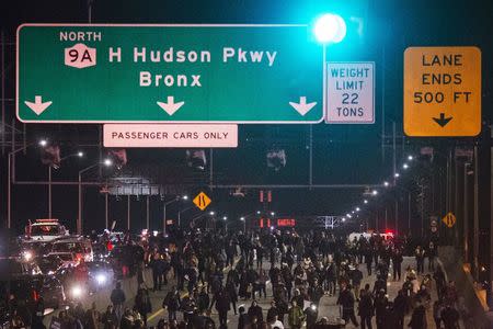 Protesters, demanding justice for the death of Eric Garner, disrupt traffic along the West Side Highway in Manhattan, New York on December 3, 2014. REUTERS/Adrees Latif