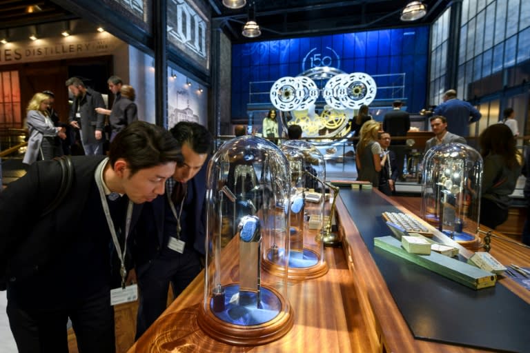 Visitors check out watches at the international luxury watchmakers show SIHH in Geneva