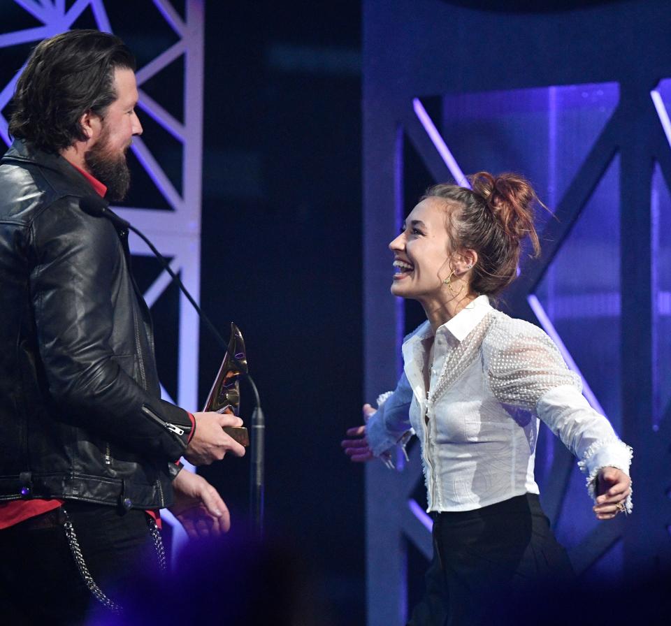 Lauren Daigle goes in for a hug with Zack Williams as she accepts artist of the year at the 50th Annual Dove Awards in Nashville on Tuesday.