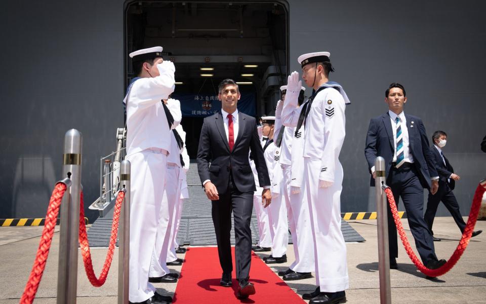 The Prime Minister steps off a Japanese aircraft carrier and inspects a guard of honour ahead of the G7 Summit - Stefan Rousseau/PA Wire