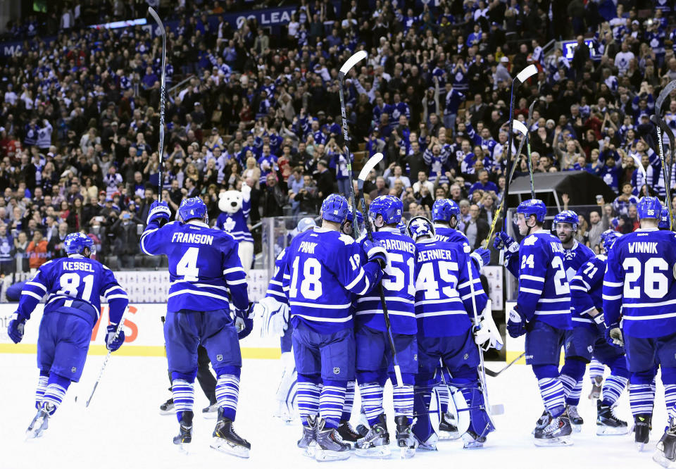 The Toronto Maple Leafs salute the crowd following a win over the Detroit Red Wings in an NHL hockey game in Toronto on Saturday, Nov. 22, 2014. (AP Photo/The Canadian Press, Frank Gunn)