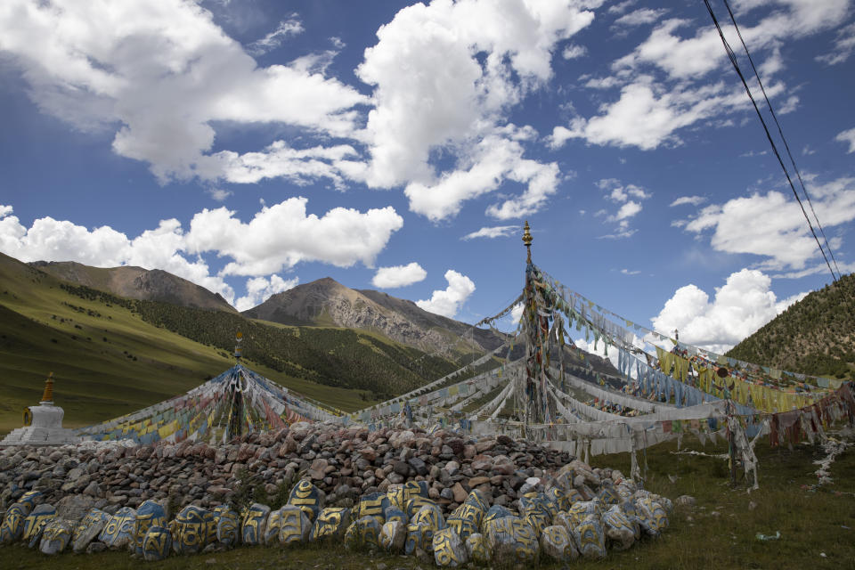 Tibetan prayer flags are seen during a clear day in Angsai, an area inside the Sanjiangyuan region in western China's Qinghai province on Monday, Aug. 26, 2019. Qinghai is a vast region in western China abutting Tibet and shares much of its cultural legacy. (AP Photo/Ng Han Guan)