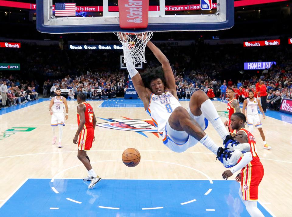 Oklahoma City's Jalen Williams (8) hangs on to the rim after a dunk in the first half during the NBA basketball game between the Oklahoma City Thunder and the Atlanta Hawks at the Paycom Center  in Oklahoma City, Wednesday, Jan.25, 2023. 