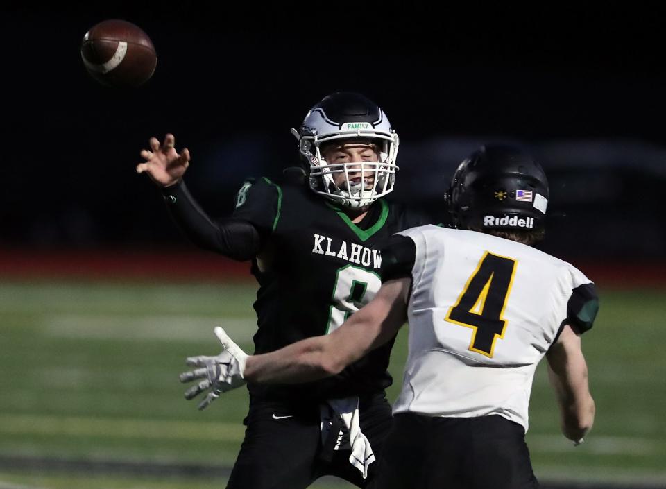 Klahowya Eagles quarterback Jack Kealoha (8) passes the ball while under pressure by Vashon Island’s Tiegin Monson (4) during the second half of their game on Thursday, Sept. 28, 2023. Klahowya won the game 27-7.