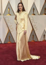 <p>Dakota Johnson, star of <em>Fifty Shades Darker</em>, completely covered up in a long-sleeved gold gown from Gucci. <em>(Photo: Getty Images)</em> </p>