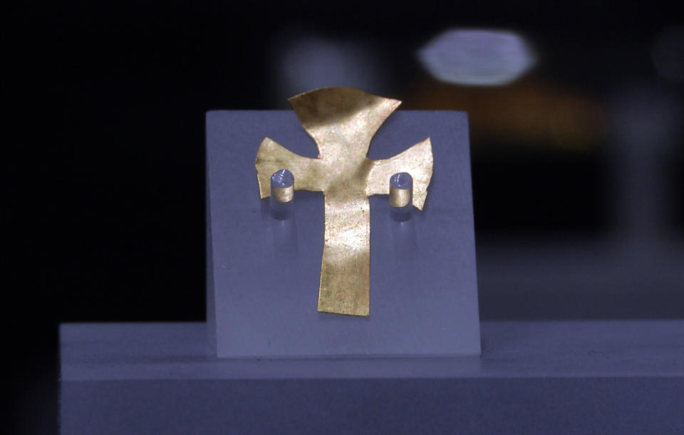 A gold foil cross uncovered at an Anglo-Saxon burial site in the village of Prittlewell in 2003 on display at Southend Central Museum in Southend, England, Thursday, May 8, 2019. Archaeologists say an underground chamber discovered accidentally by road workers may be the site of the earliest Christian royal burial in Britain. The chamber uncovered between a road and a railway line in the village of Prittlewell in 2003 turned out to be a 1,400-year-old burial site. (AP Photo/James Brooks)